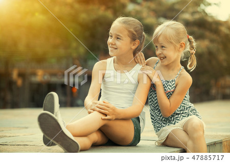Two girls looking into distance outdoors 47885717