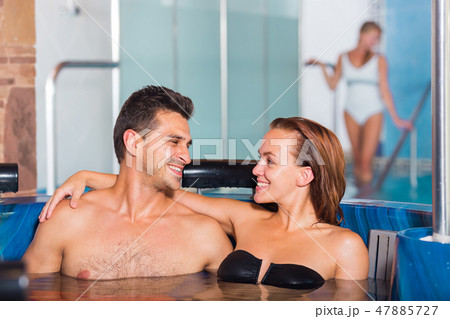 Couple is resting in pool in time spa-day Couple is resting in pool in time spa-day 47885727