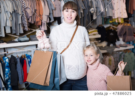 Adult mother and girl enjoying their purchases 47886025