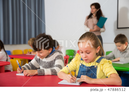 School kids studying in classroom 47886512