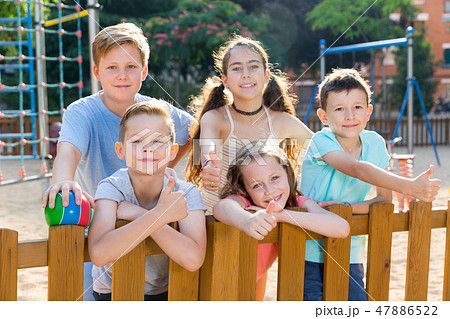 Glad kids posing at the playground and thumbs up Glad kids posing at the playground and thumbs up 47886522