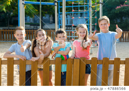 Glad kids posing at the playground and thumbs upの写真素材 [47886566] - PIXTA