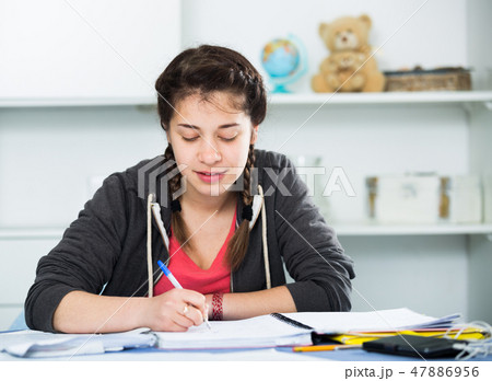 Girl doing homework 47886956