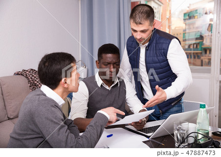 Serious men with documents at home 47887473