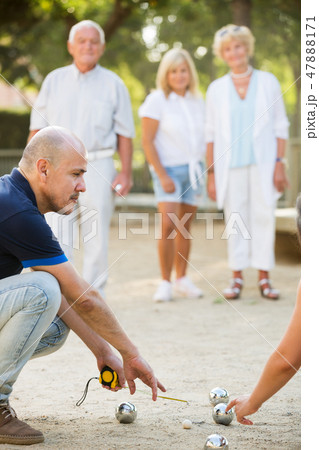 Mature people playing bocce Mature people playing bocce 47888171