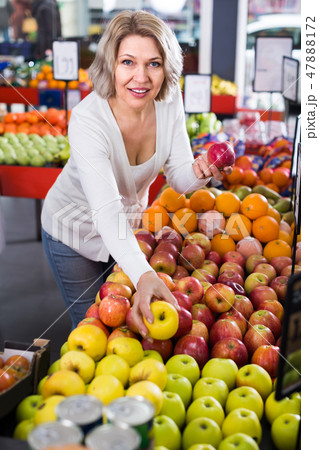Woman selecting fruits in grocery . Woman selecting fruits in grocery . 47888172