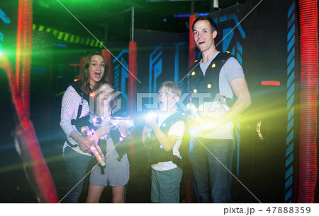 Kids and parents in beams during laser tag game 47888359