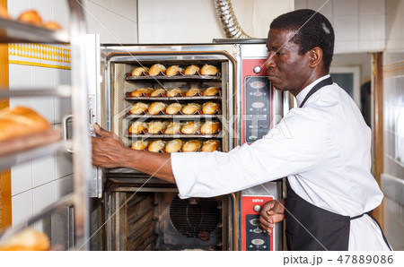 Baker controlling process of baking bread in oven 47889086