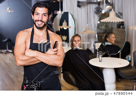 Portrait of sexy adult man hairdresser standing Portrait of sexy adult man hairdresser standing 47890544