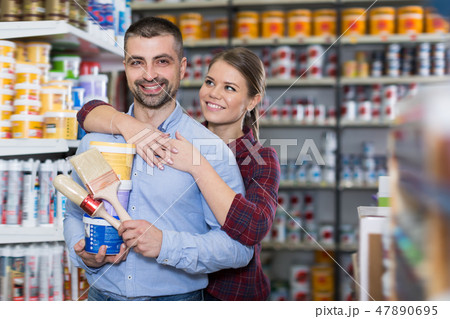 Glad woman and man with paint and brushes Glad woman and man with paint and brushes 47890695