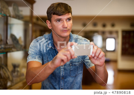 Man taking pictures in historical museum 47890818