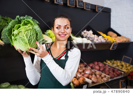 Woman choosing cabbage in grocery shop Woman choosing cabbage in grocery shop 47890840
