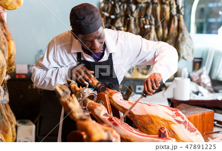 Seller slicing jamon Seller slicing jamon 47891225