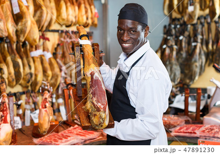 Seller recommending iberian ham Seller recommending iberian ham 47891230