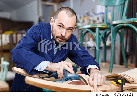 Craftsman repairing antique furniture Craftsman repairing antique furniture 47891322