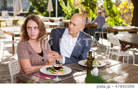 Family quarrel during lunch in an open-air restaurant 47892000