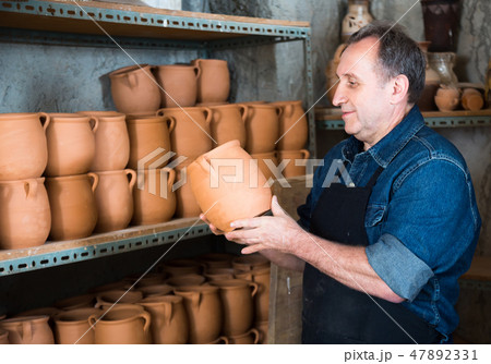 Elderly potter at ceramic workshop. Elderly potter at ceramic workshop. 47892331