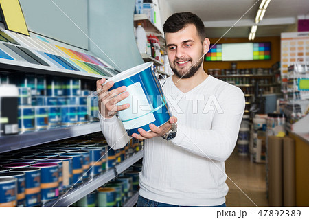 Guy is deciding on best wall paint 47892389