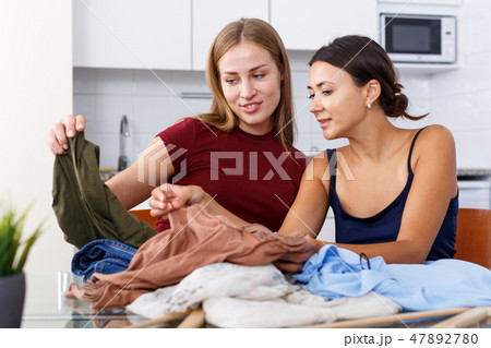 Women showing each other clothes 47892780