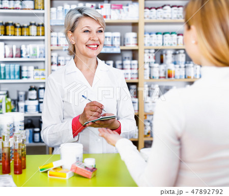 Mature female seller suggesting care products to young customer 47892792