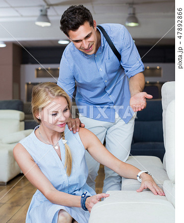 Family couple are choosing new sofa-transformer Family couple are choosing new sofa-transformer 47892866
