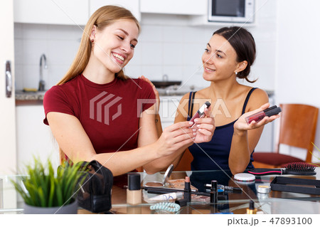 Female friends applying cosmetics 47893100