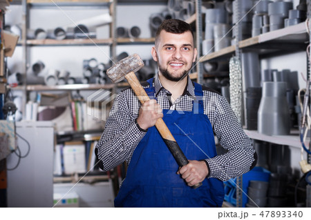 Smiling male builder showing constructing instruments 47893340