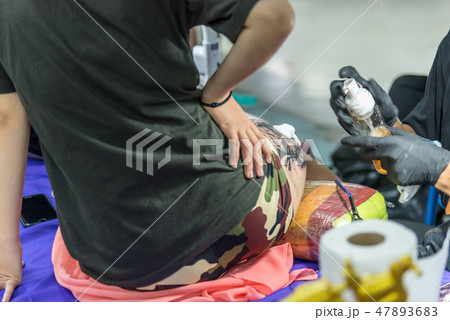 Tattoo artist drawing art on body Tattoo artist drawing art on body 47893683