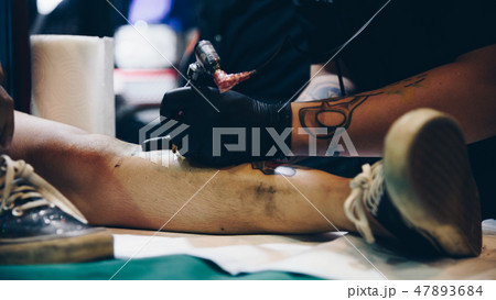 Tattoo artist drawing art on body Tattoo artist drawing art on body 47893684