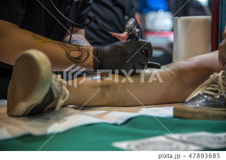 Tattoo artist drawing art on body Tattoo artist drawing art on body 47893685