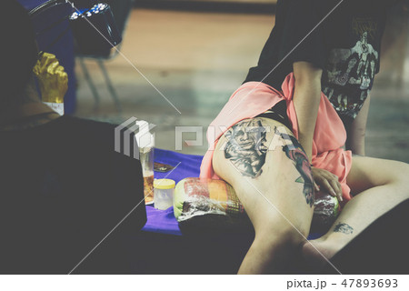 Tattoo artist drawing art on body 47893693
