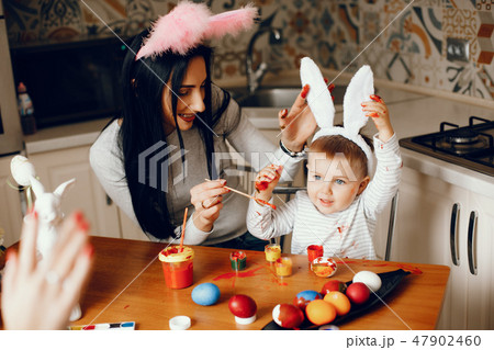 Mother with little son in a kitchen Mother with little son in a kitchen 47902460