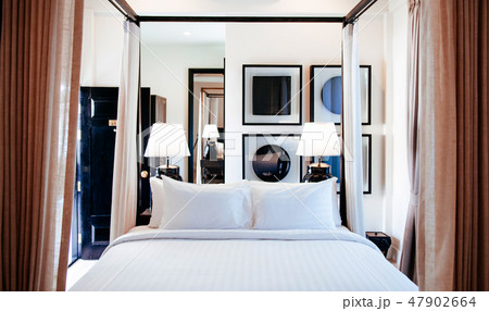 Contemporary hotel bedroom with four poster bed Contemporary hotel bedroom with four poster bed 47902664