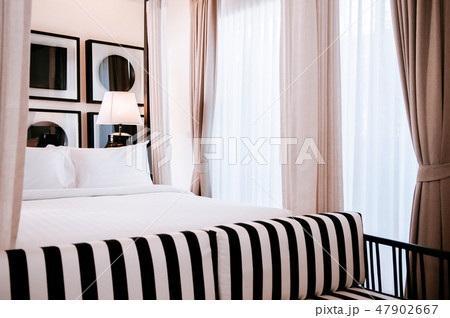 Contemporary hotel bedroom with four poster bed Contemporary hotel bedroom with four poster bed 47902667