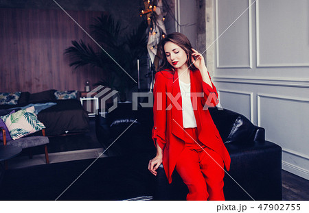 stylish woman in a red suit 47902755