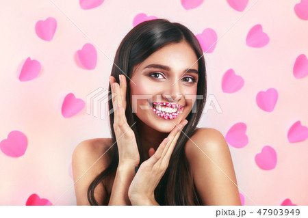 Valentine Hearts sweet makeup. Valentine's Day make-up lips with pink hearts sugar sprinkles. Kiss Valentine Hearts sweet makeup. Valentine's Day make-up lips with pink hearts sugar sprinkles. Kiss 47903949