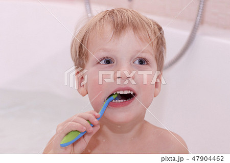 Adorable Baby boy cleaning teeth. Cute toddler with toothbrush in the bath Adorable Baby boy cleaning teeth. Cute toddler with toothbrush in the bath 47904462