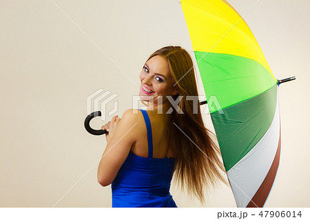 Woman in summer dress holds colorful umbrella 47906014