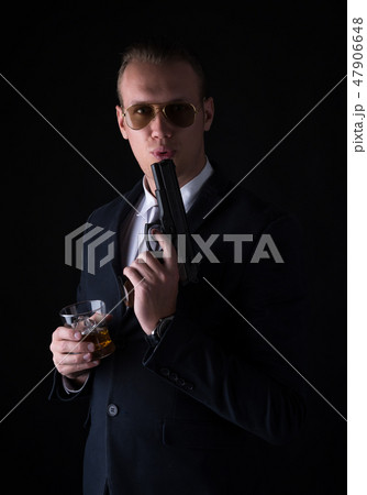 Portrait of handsome man in a suit with blowing on Portrait of handsome man in a suit with blowing on 47906648