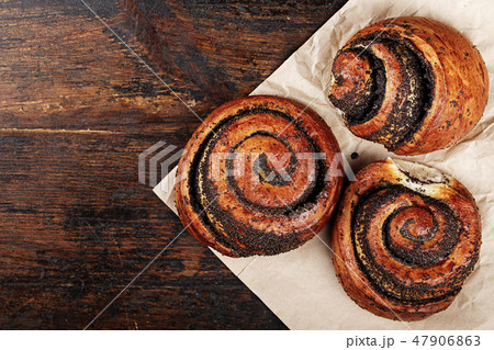 rolls with poppy seeds on a plain napkin 47906863
