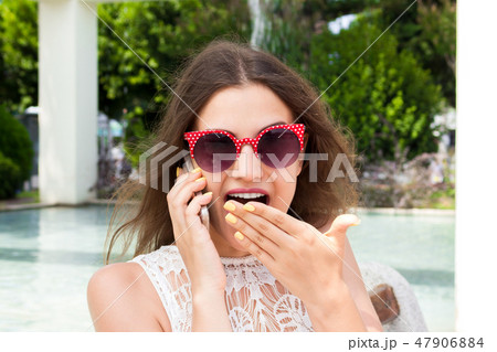 Shocked Young Female Talking on Cell Phone Shocked Young Female Talking on Cell Phone 47906884