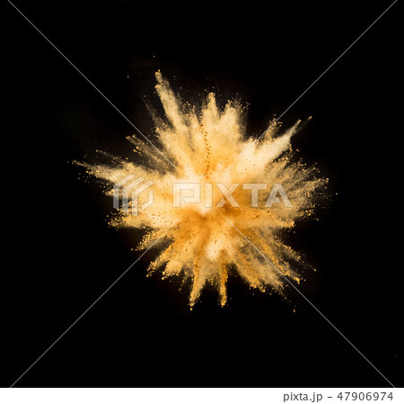 Golden powder explosion on black background. 47906974