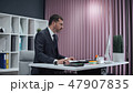 Businessman working in office, standing work at computer. 47907835