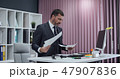 Businessman working in office, standing work at computer. 47907836