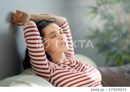 woman resting on sofa woman resting on sofa 47909043