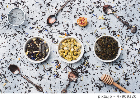 Variety of dry tea leaves and flowers in bowl  47909320