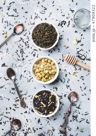 Variety of dry tea leaves and flowers in bowl  47909322