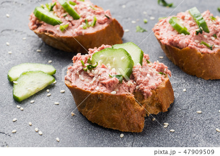 Sandwiches with chicken pate and cucumber  47909509