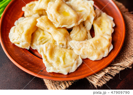 The boiled made dumplings with a stuffing  47909790