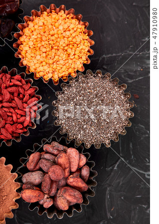 Various superfoods in small bowl black background 47910980